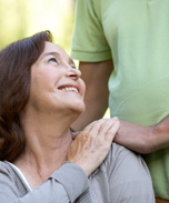 man putting hands on his mother's shoulder