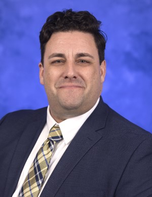 Headshot of Braden (Brad) Linn wearing a suit and tie