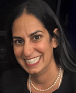 Headshot of Seem Clifasefi wearing a dark blouse and pearl necklace